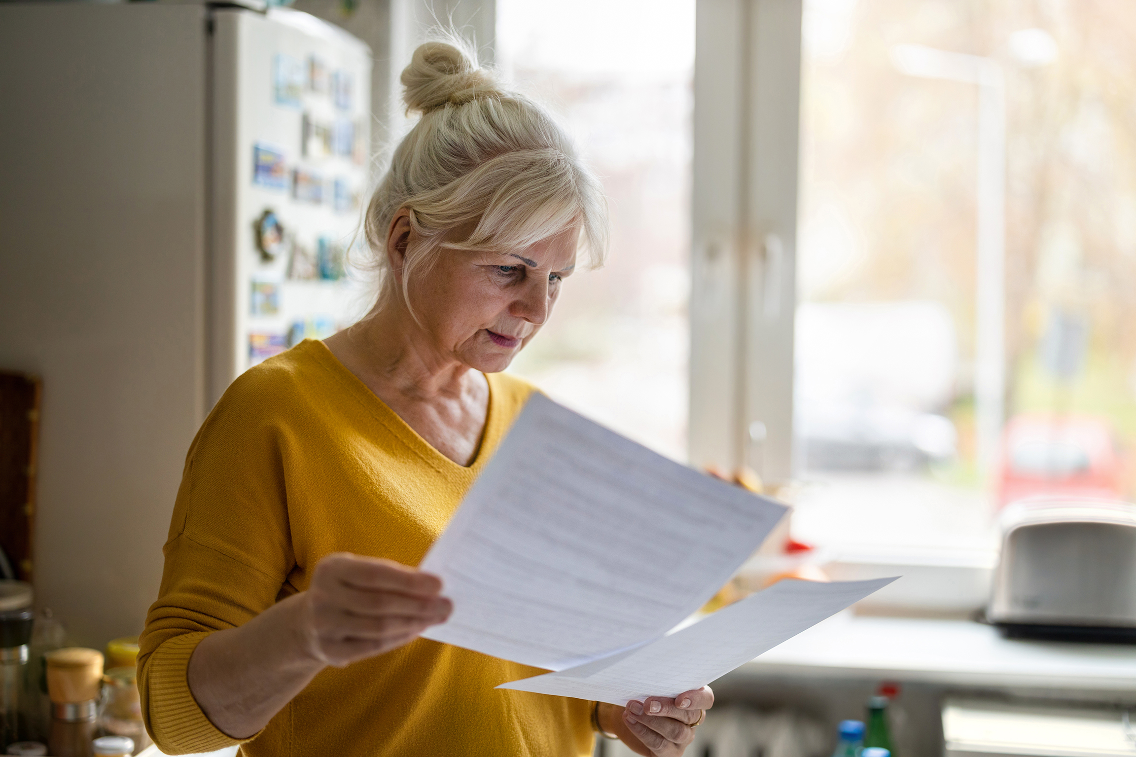 Senior woman reading documentation
